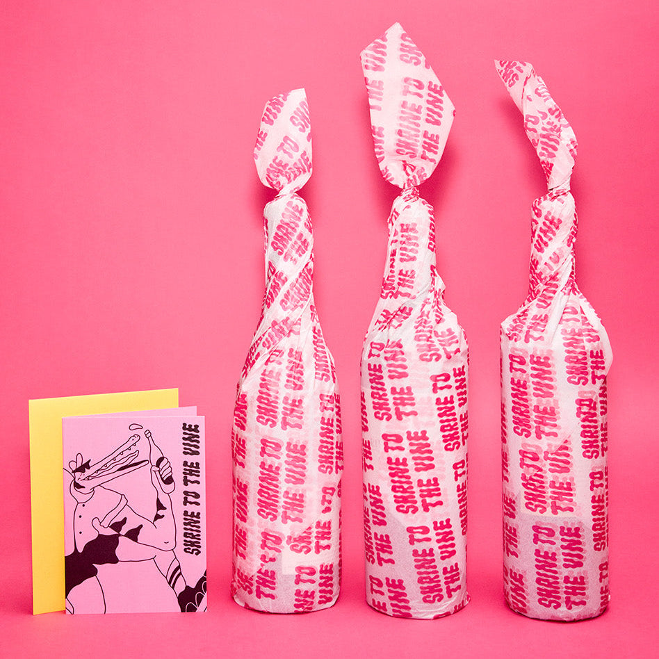 A Shrine to the Vine monthly wine subscription selection, wrapped with a gift card.